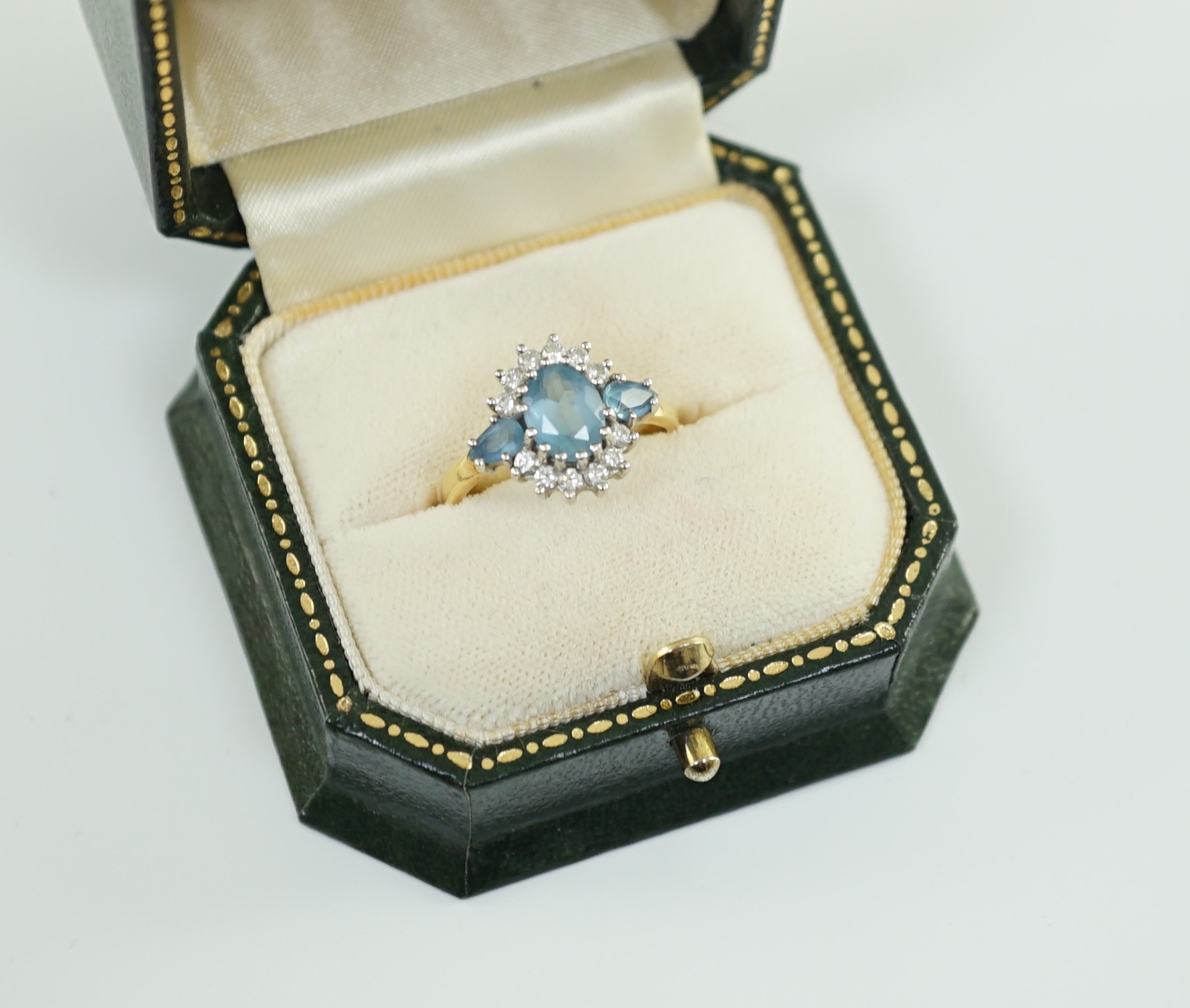 A 1970's 18ct gold, aquamarine and diamond set oval cluster ring, by Cropp & Farr